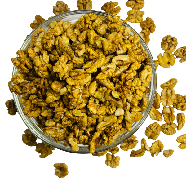 Nuts for Wellness Glass bowl filled with walnuts on a white background