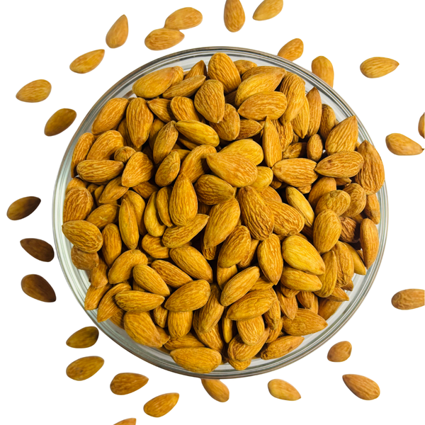 Nuts For Wellness Glass bowl filled with almonds on a white background