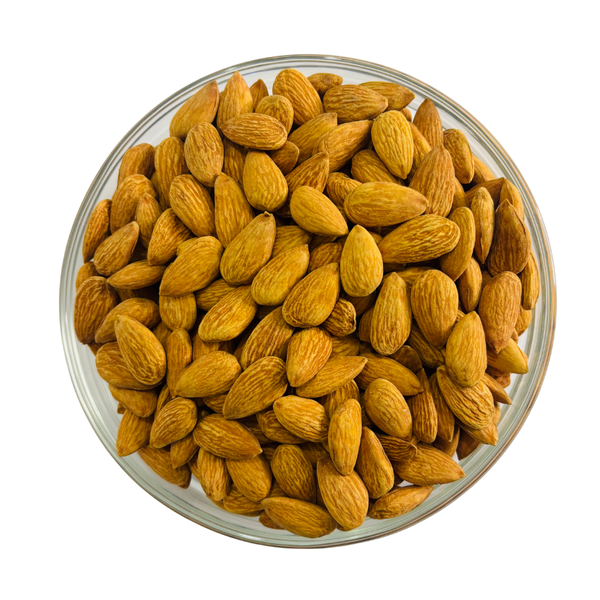 Nuts For Wellness Glass bowl filled with almonds on a white background