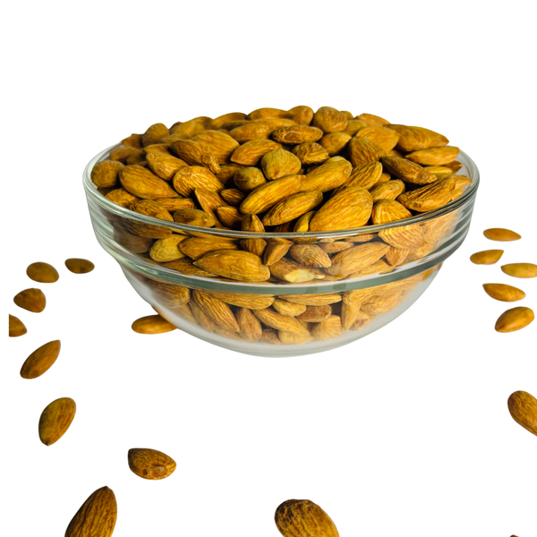 Nuts For Wellness Glass bowl filled with almonds on a white background