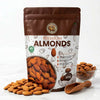 Nuts For Wellness Almond Bag of premium almonds with a wooden scoop and scattered almonds on a white background