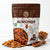Nuts For Wellness Almond Bag of premium almonds with a wooden scoop and scattered almonds on a white background