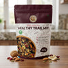 Nuts For WellnessPremium healthy trail mix 250g package on a wooden surface with visible ingredients.