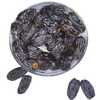 Nuts for wellness Dried figs Medjool Dates in a clear glass bowl on a white background