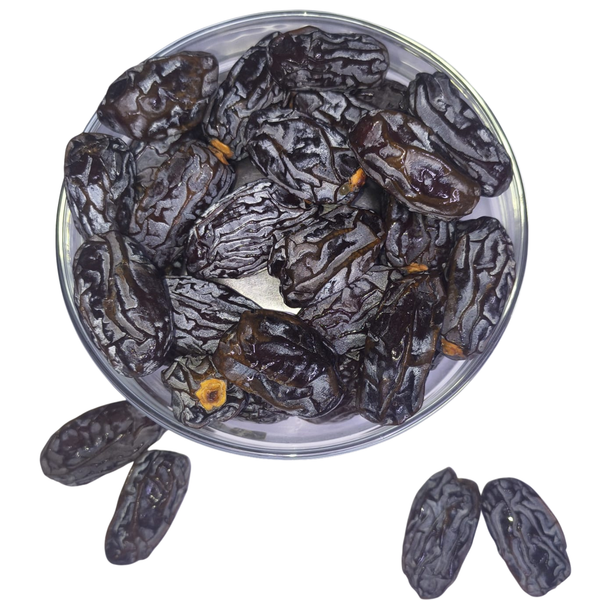 Nuts for wellness Dried figs Medjool Dates in a clear glass bowl on a white background
