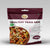 Package of premium healthy trail mix with a bowl of mix on a gray background