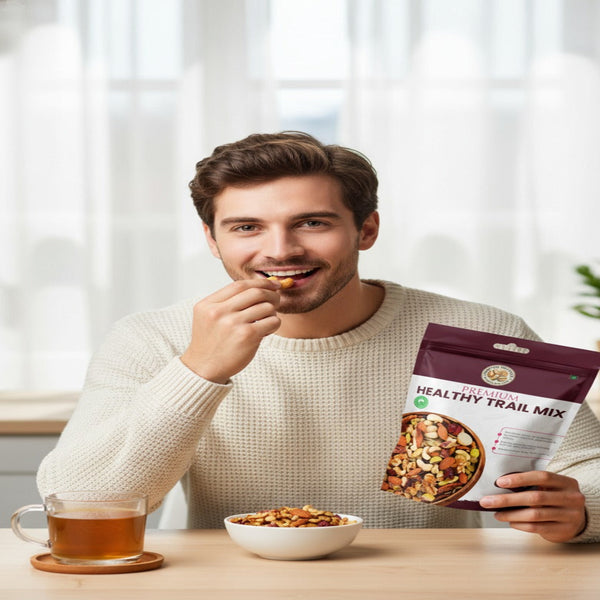 Nuts For Wellness Man enjoying a healthy snack with a package of trail mix and a cup of tea.