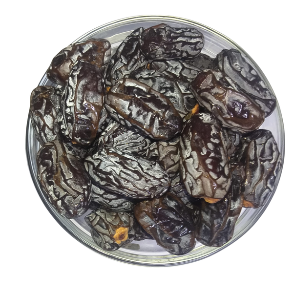 Nuts for wellness Set of six wellness combo pack packagesGlass bowl filled with dark brown dates on a white background