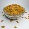 Glass bowl filled with raisins on a white background
