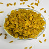 Glass bowl filled with yellow raisins on a white background